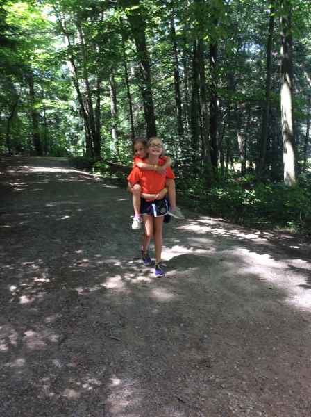 girl giving her friend a piggy back
